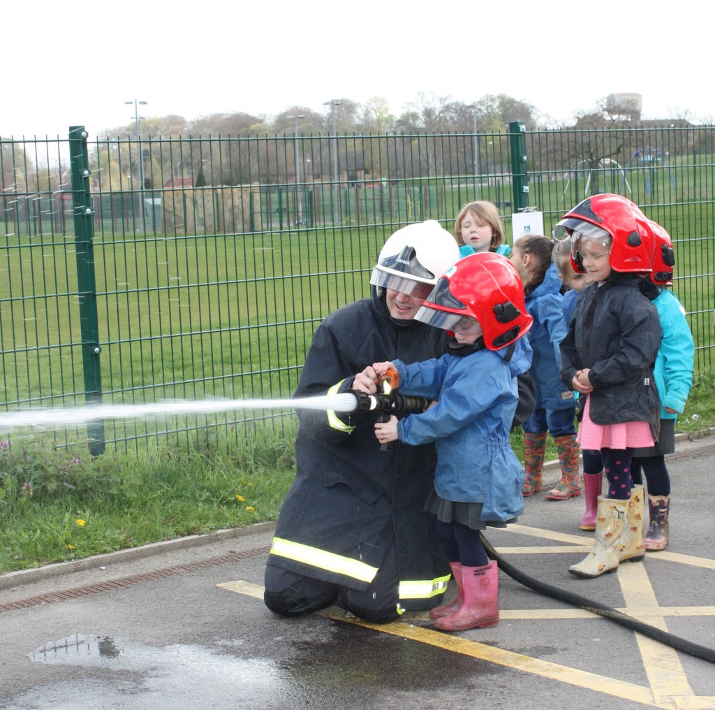 Children enjoying trying the fire safety equipment 