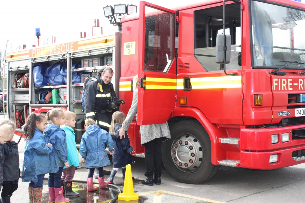 Firefighters show Henderson Green pupils around fire engine 